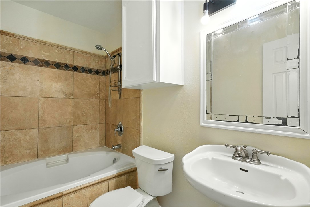 833 Orleans Drive Corpus Christi, TX 78418 - Photo 11 of 18 a bathroom with a sink a toilet and shower