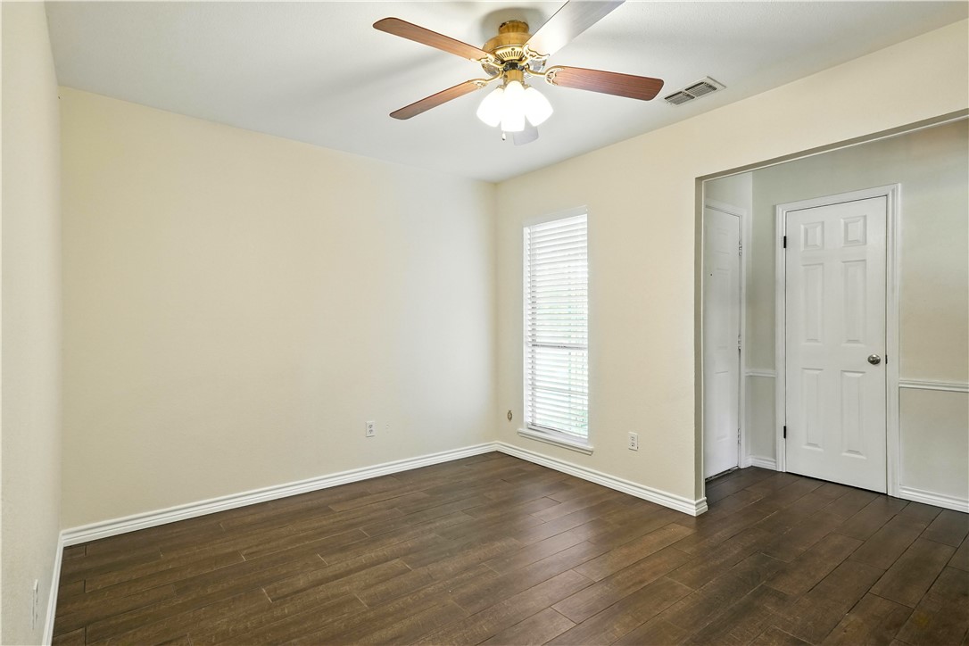 833 Orleans Drive Corpus Christi, TX 78418 - Photo 4 of 18 an empty room with wooden floor fan and windows