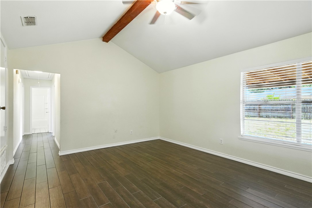 833 Orleans Drive Corpus Christi, TX 78418 - Photo 6 of 18 an empty room with wooden floor and windows
