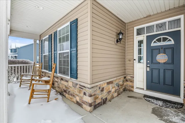 a dining room with furniture a chandelier and wooden floor
