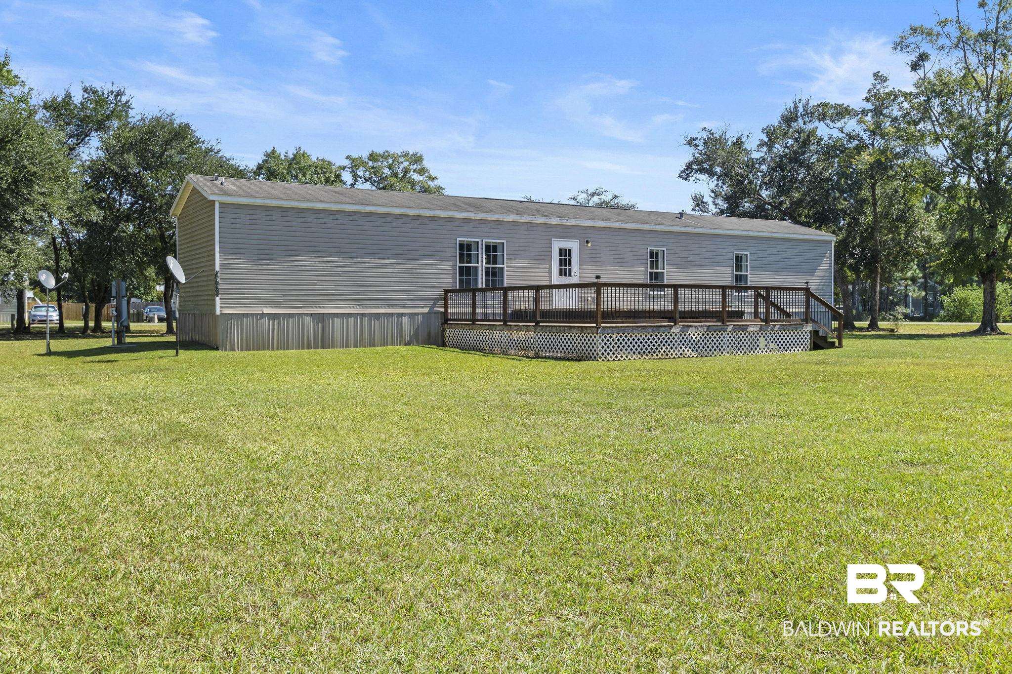 6870 Cecilia Court Theodore, AL 36582 - Photo 55 of 83 Rear view of house with a deck and a lawn