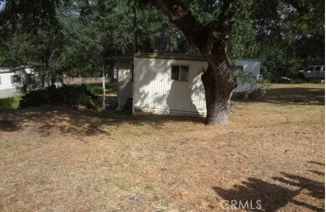 a view of backyard with tub and trees