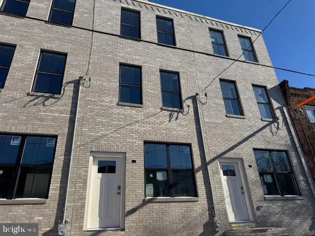 a front view of a house with many windows