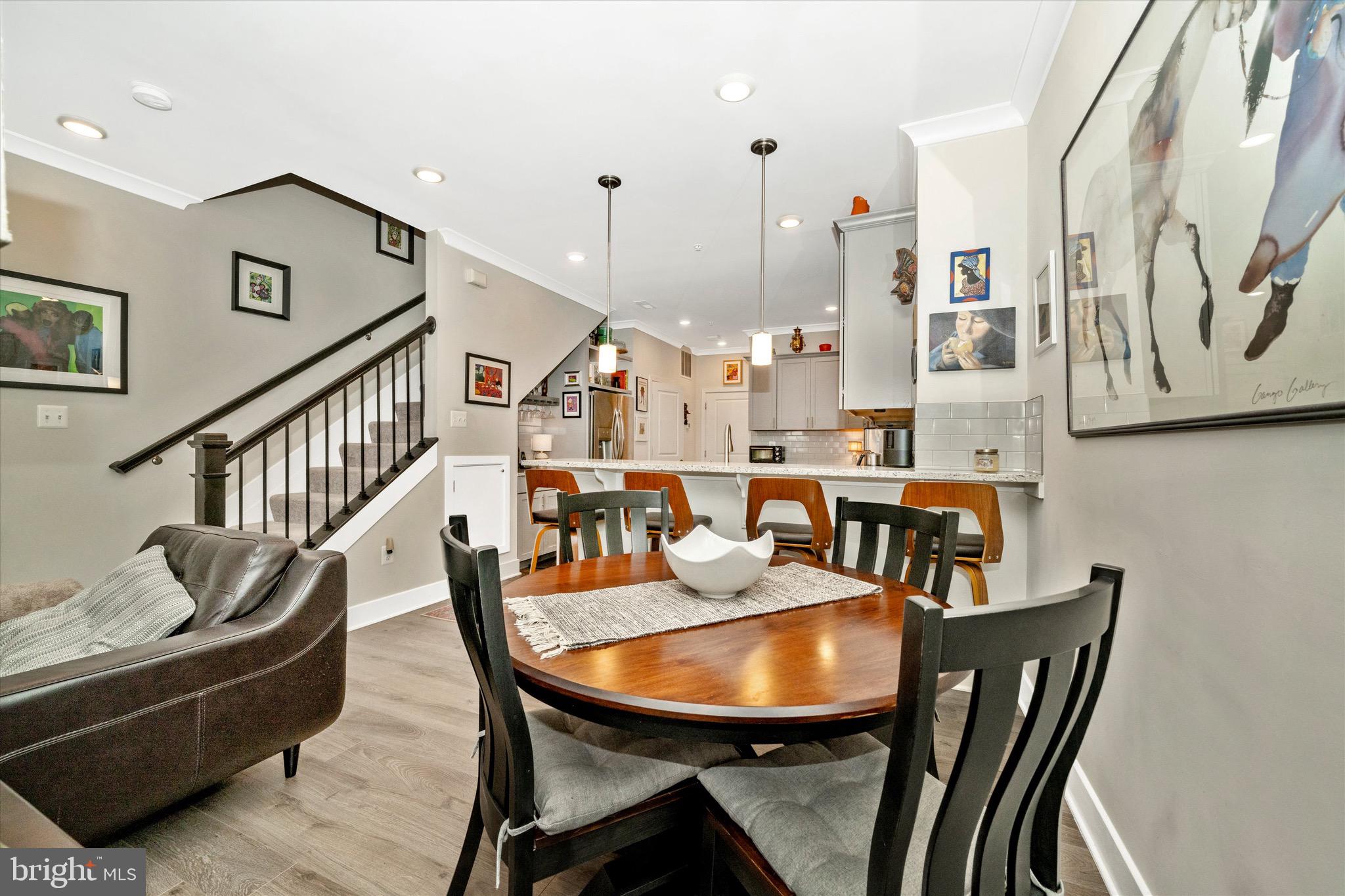 7920 Potter Place, Unit 920B Elkridge, MD 21075 - Photo 14 of 57 a dining room with furniture a rug and wooden floor