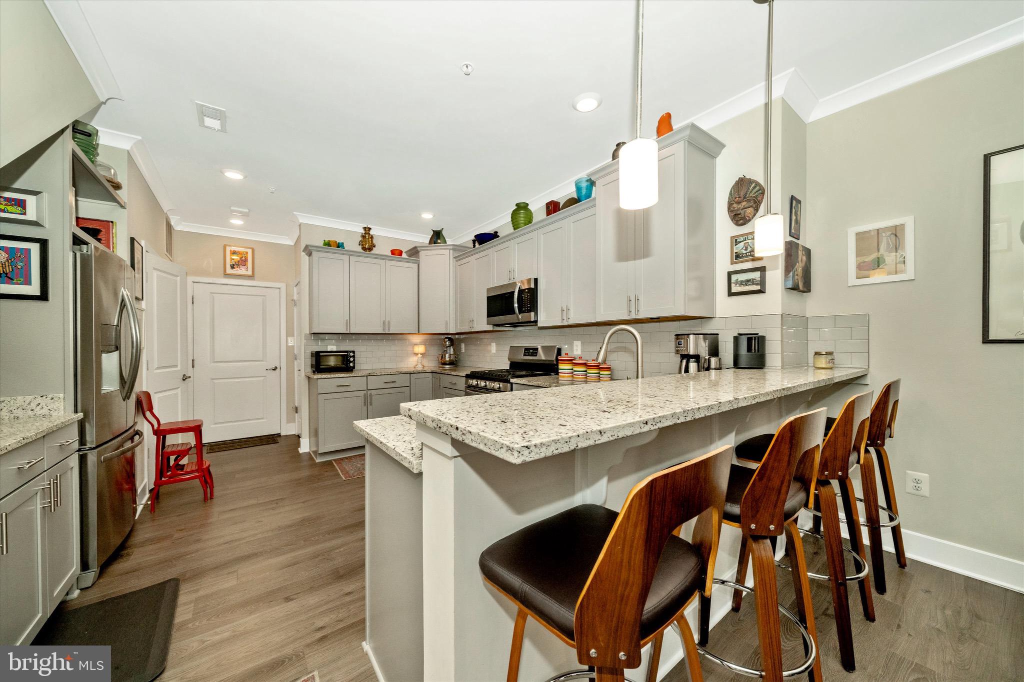 7920 Potter Place, Unit 920B Elkridge, MD 21075 - Photo 16 of 57 a kitchen with stainless steel appliances granite countertop a sink refrigerator and cabinets