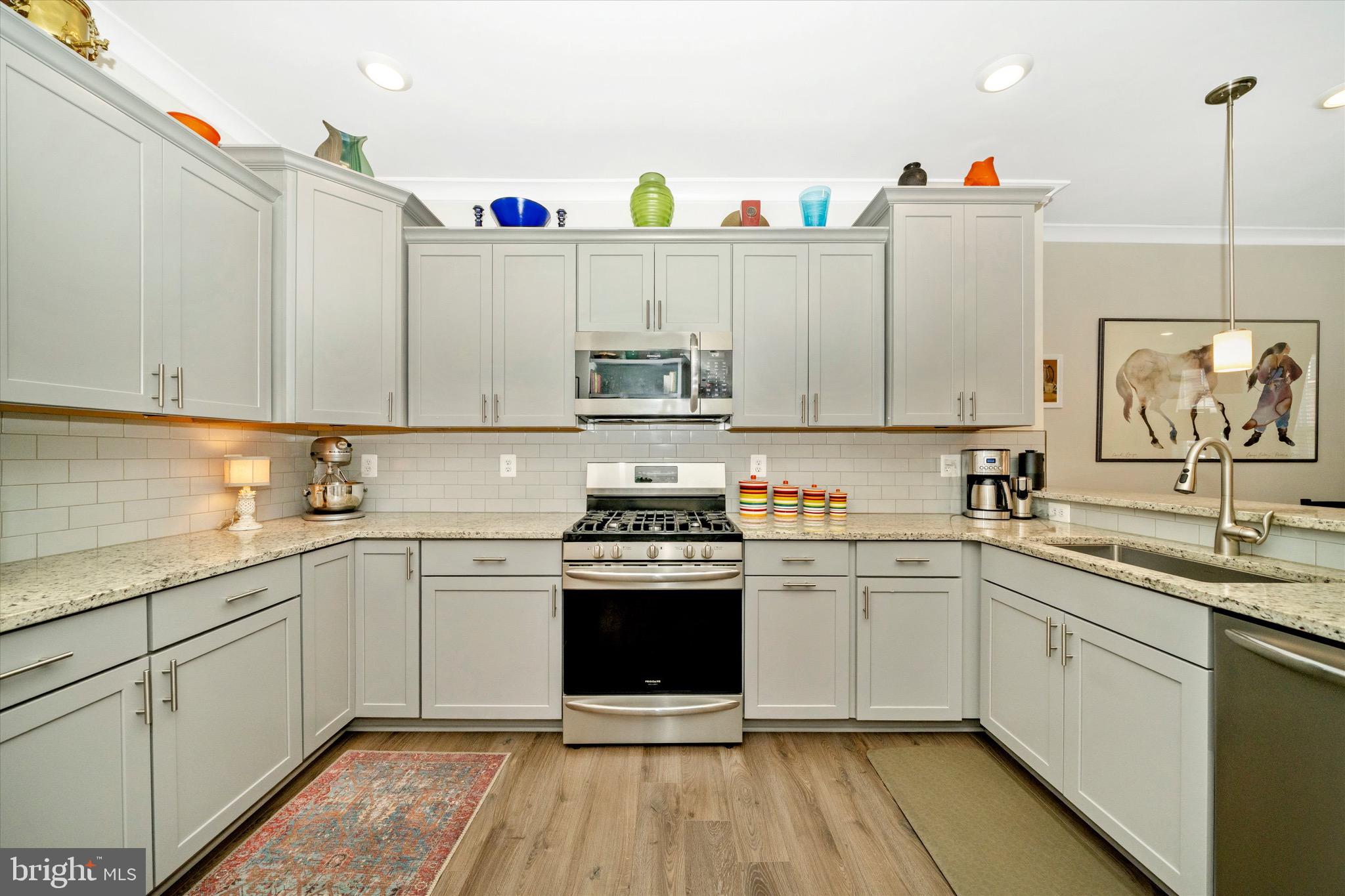 7920 Potter Place, Unit 920B Elkridge, MD 21075 - Photo 18 of 57 a kitchen with a sink stove and cabinets
