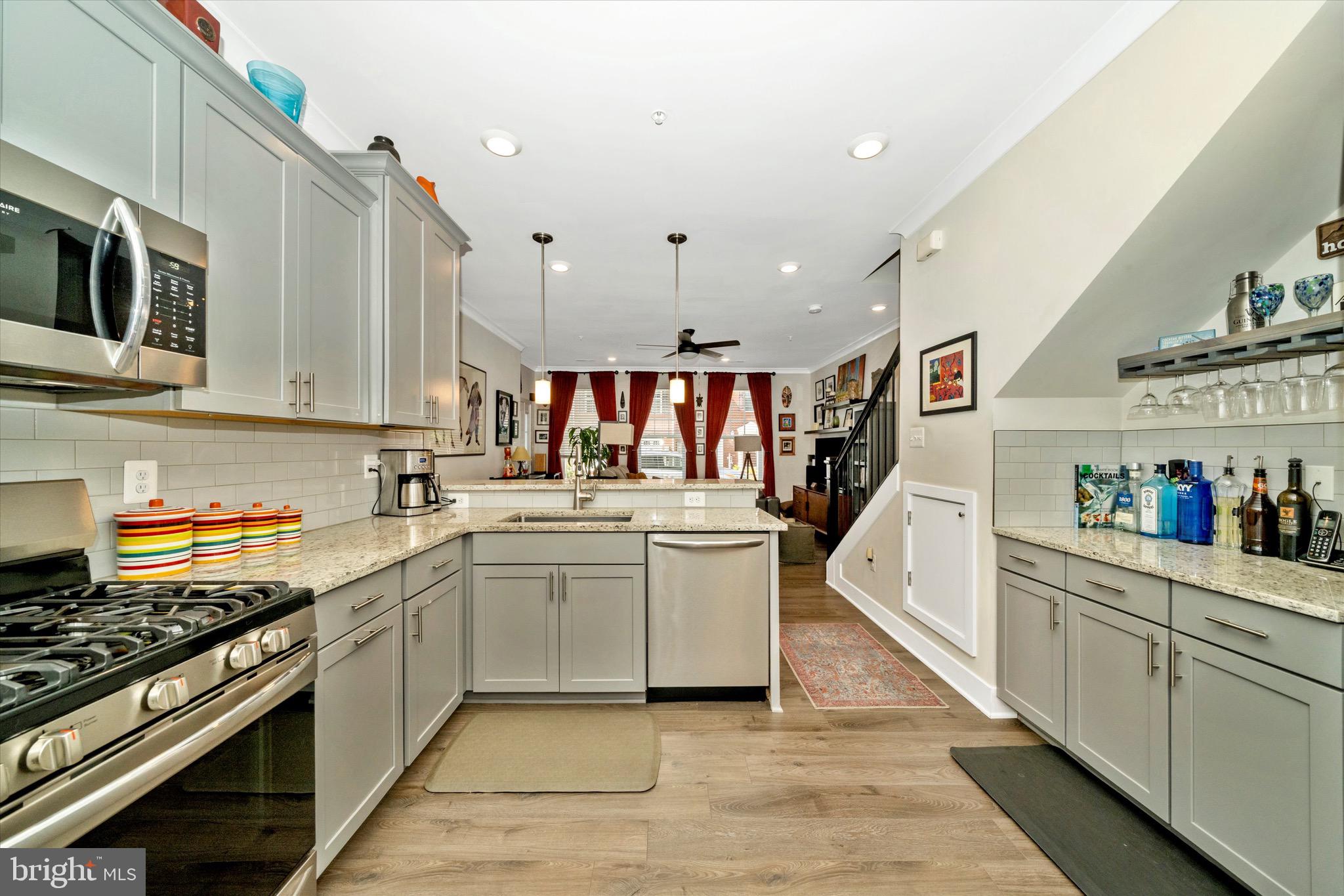 7920 Potter Place, Unit 920B Elkridge, MD 21075 - Photo 20 of 57 a kitchen with stainless steel appliances granite countertop a stove and a sink