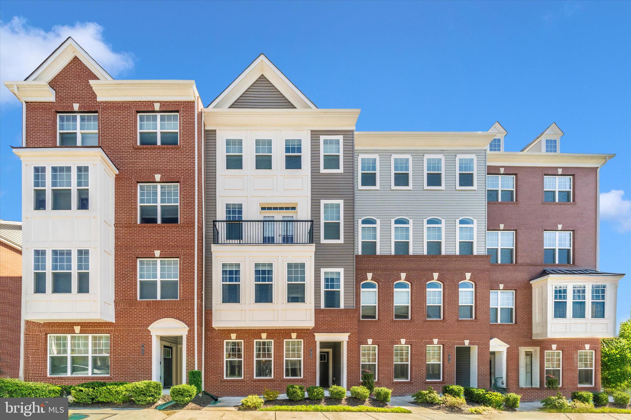 7920 Potter Place, Unit 920B Elkridge, MD 21075 - Photo 2 of 57 a front view of a brick building next to a yard