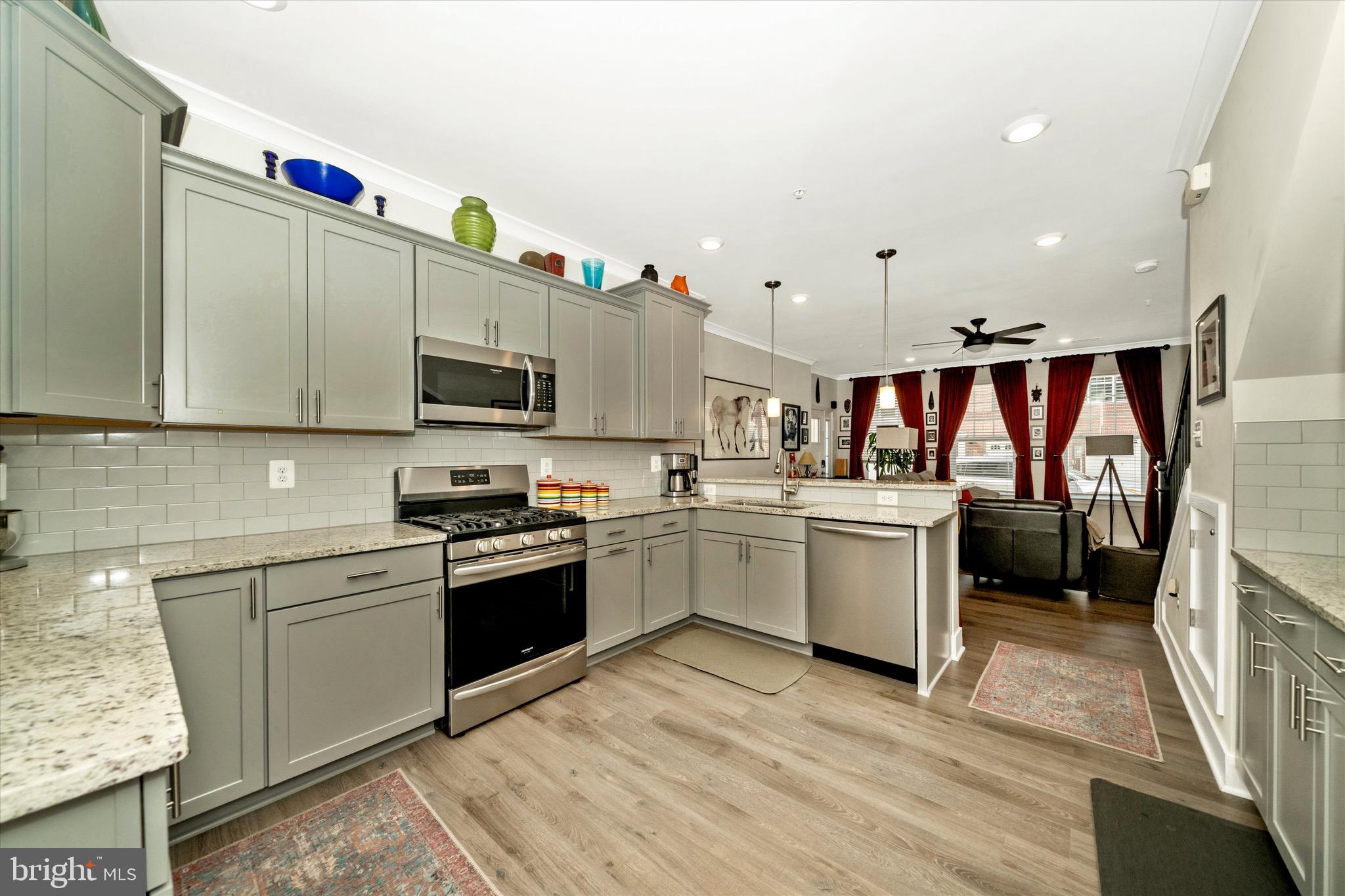 7920 Potter Place, Unit 920B Elkridge, MD 21075 - Photo 21 of 57 a kitchen with a sink cabinets and appliances