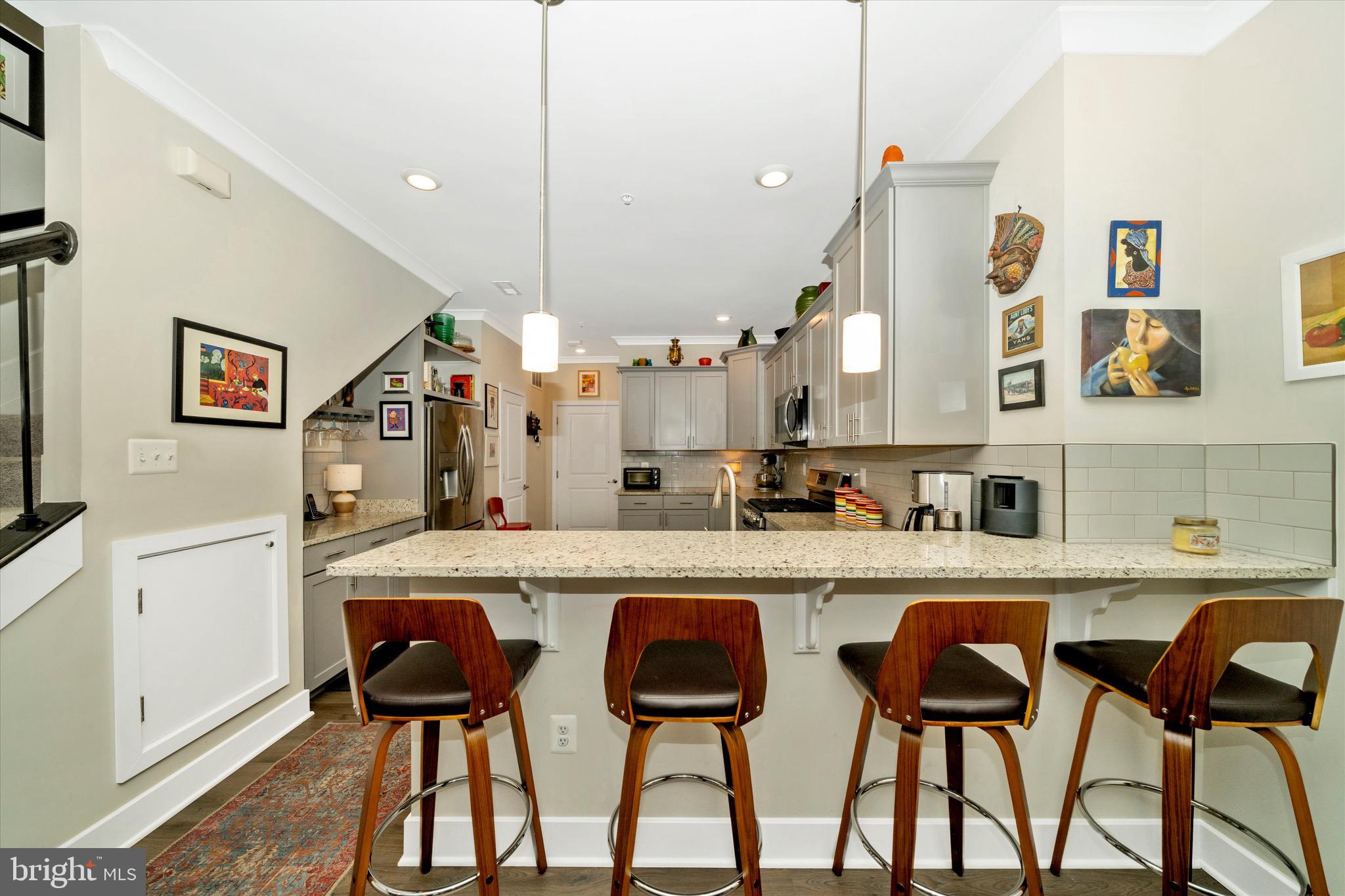7920 Potter Place, Unit 920B Elkridge, MD 21075 - Photo 22 of 57 a kitchen with cabinets and chairs
