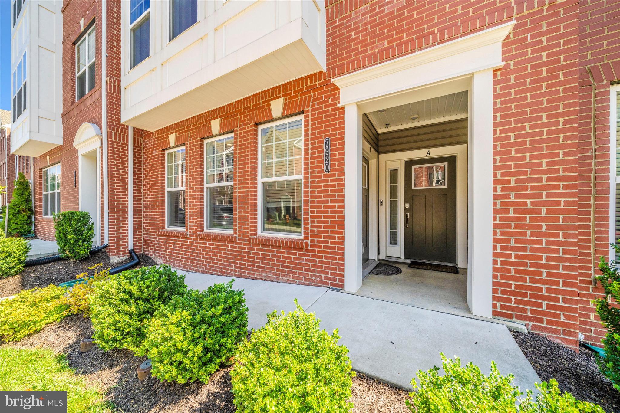 7920 Potter Place, Unit 920B Elkridge, MD 21075 - Photo 3 of 57 a view of a brick house with potted plants
