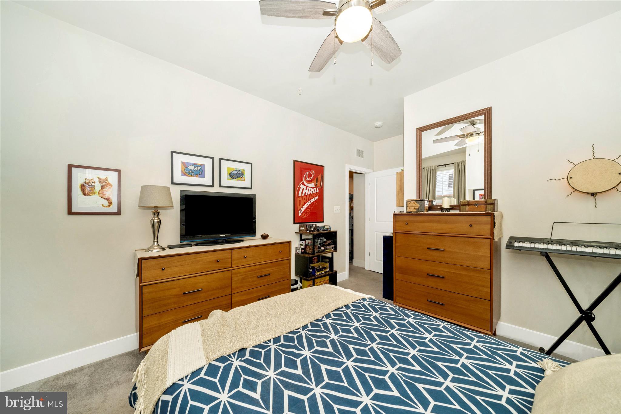 7920 Potter Place, Unit 920B Elkridge, MD 21075 - Photo 41 of 57 a bedroom with a bed and flat screen tv