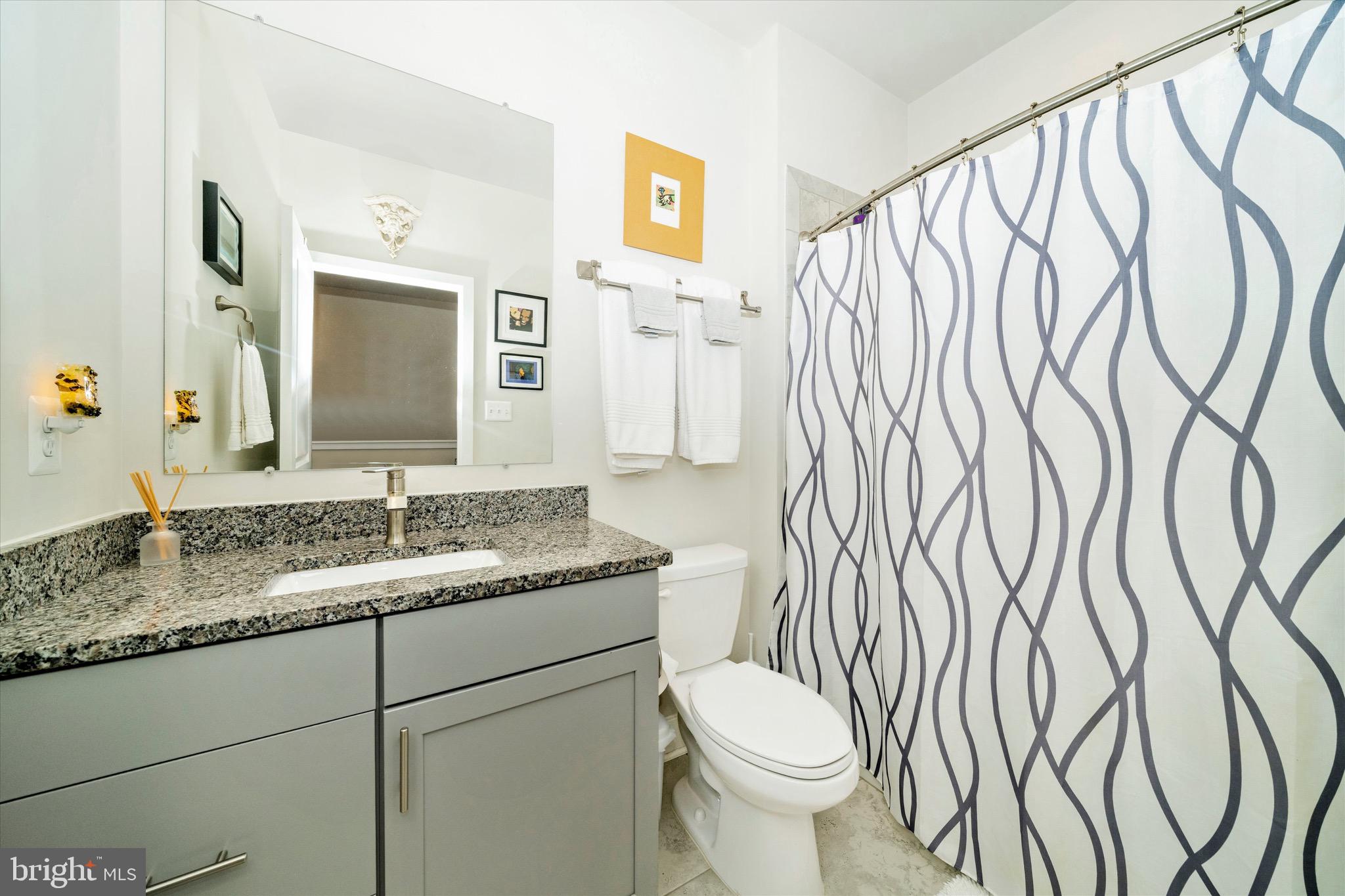 7920 Potter Place, Unit 920B Elkridge, MD 21075 - Photo 43 of 57 a bathroom with a granite countertop sink and a mirror