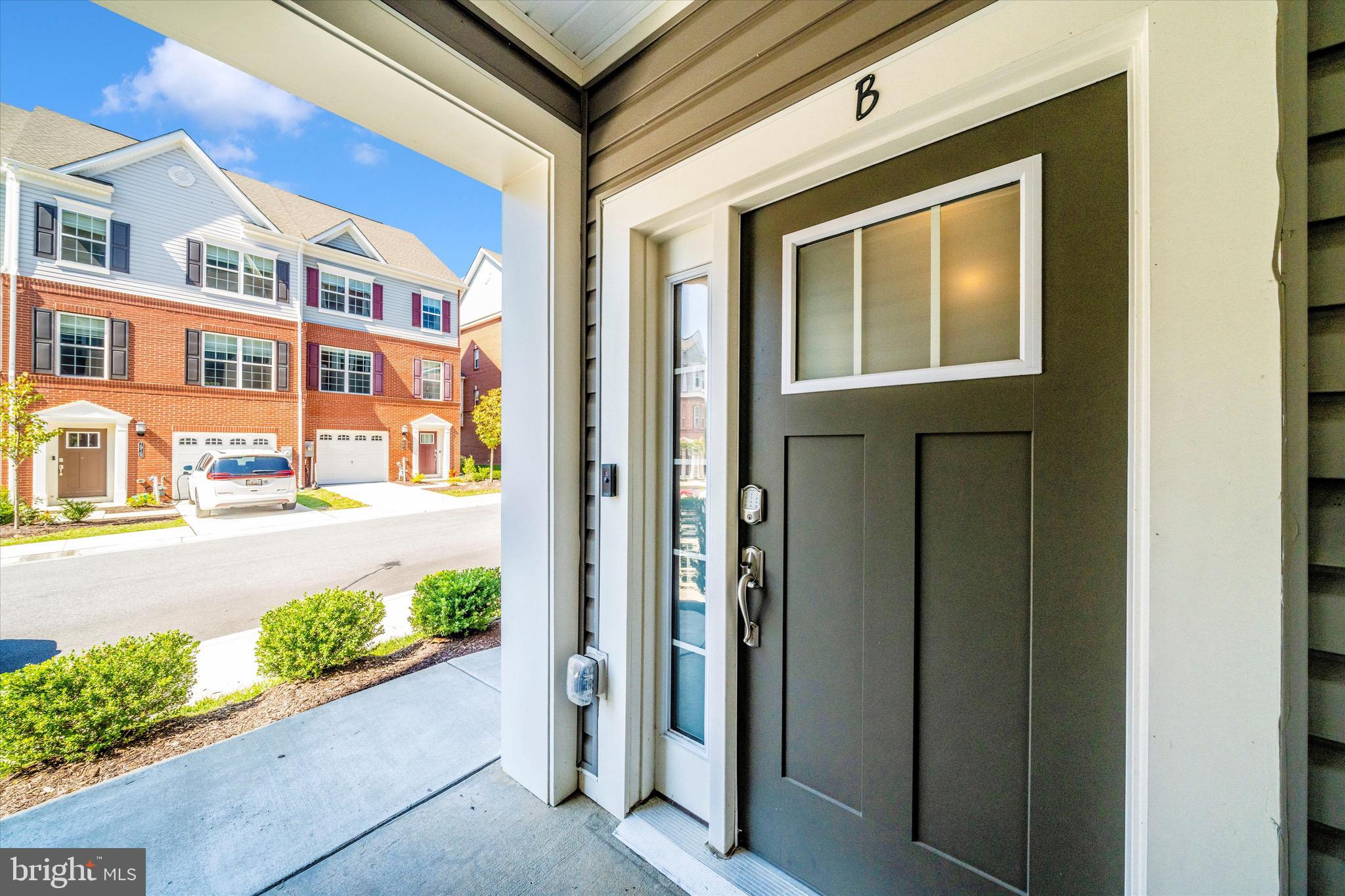 7920 Potter Place, Unit 920B Elkridge, MD 21075 - Photo 6 of 57 a front view of a building with a garden