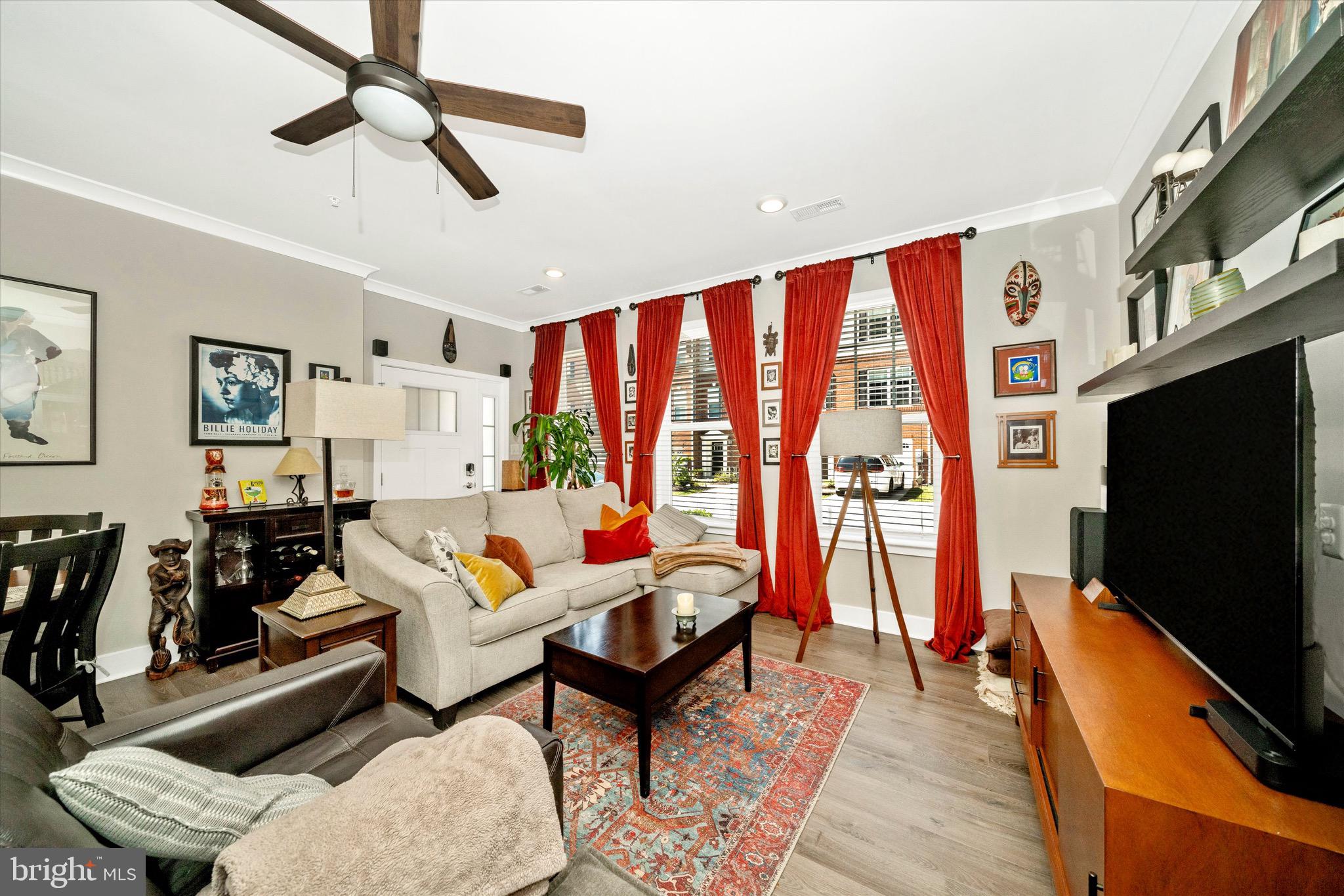 7920 Potter Place, Unit 920B Elkridge, MD 21075 - Photo 10 of 57 a living room with furniture a flat screen tv and a floor to ceiling window