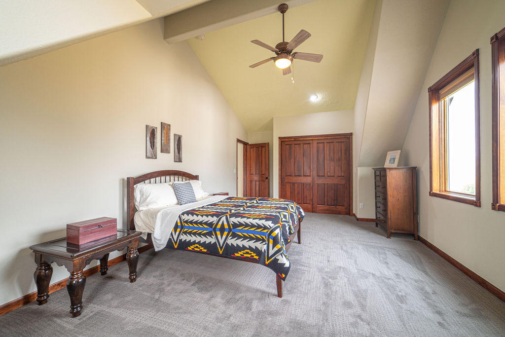 60675 Billadeau Road Bend, OR 97702 - Photo 39 of 87 a bedroom with a bed and a chandelier