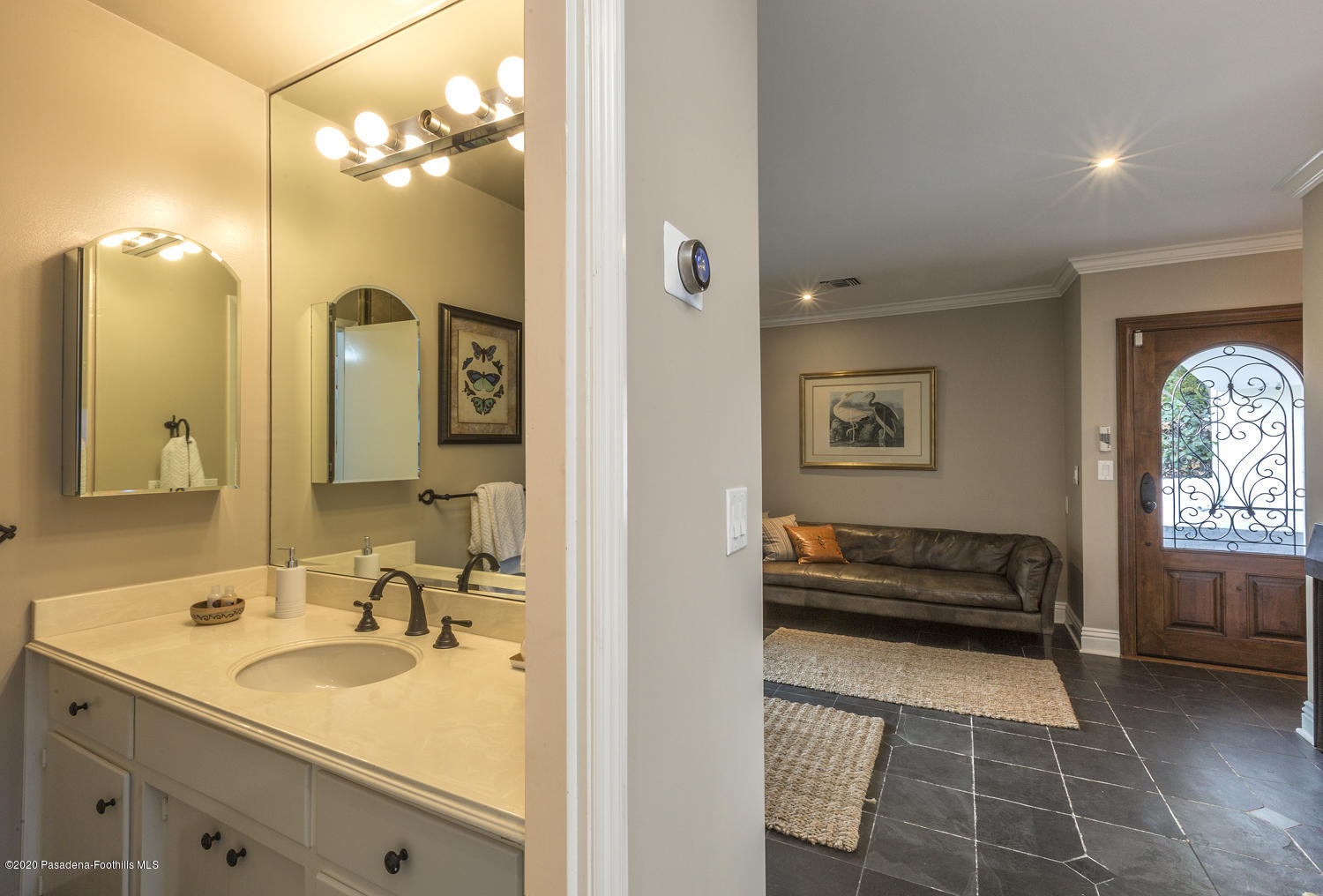 1175 Arden Road Pasadena, CA 91106 - Photo 23 of 30 a en suite bathroom with a double vanity sink and a mirror