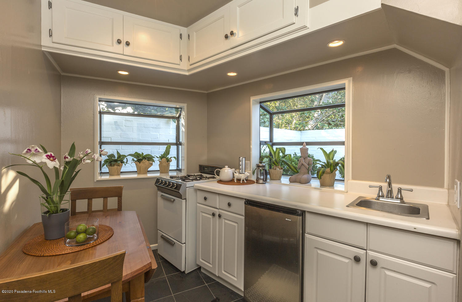 1175 Arden Road Pasadena, CA 91106 - Photo 27 of 30 a kitchen with a sink stove and cabinets