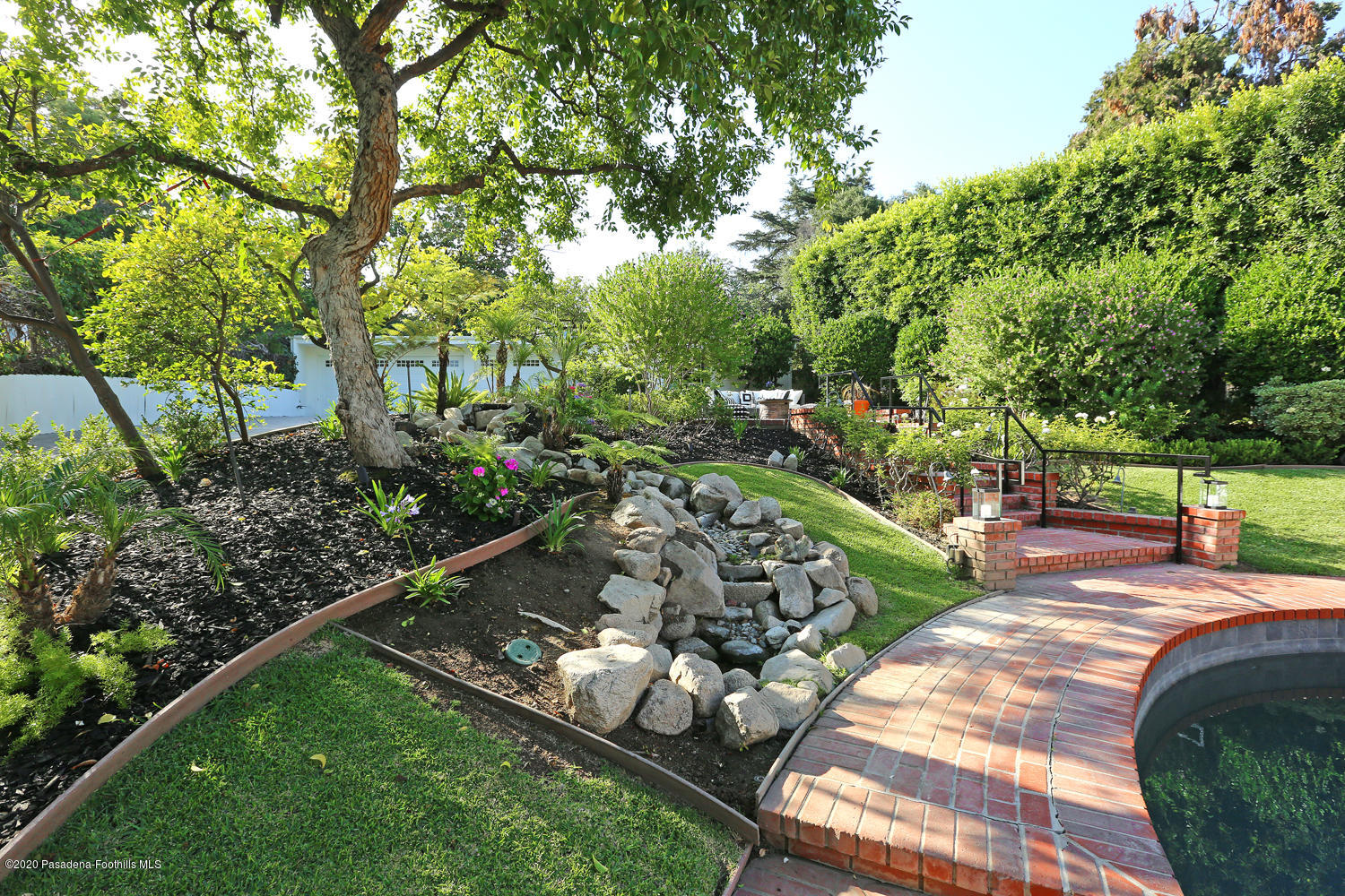 1175 Arden Road Pasadena, CA 91106 - Photo 30 of 30 a view of a backyard with table and chairs potted plants and large tree