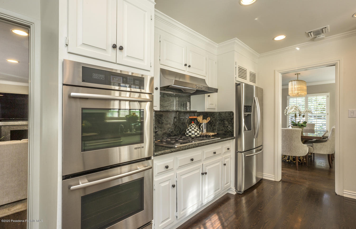 1175 Arden Road Pasadena, CA 91106 - Photo 7 of 30 a kitchen with stainless steel appliances white cabinets and wooden floors