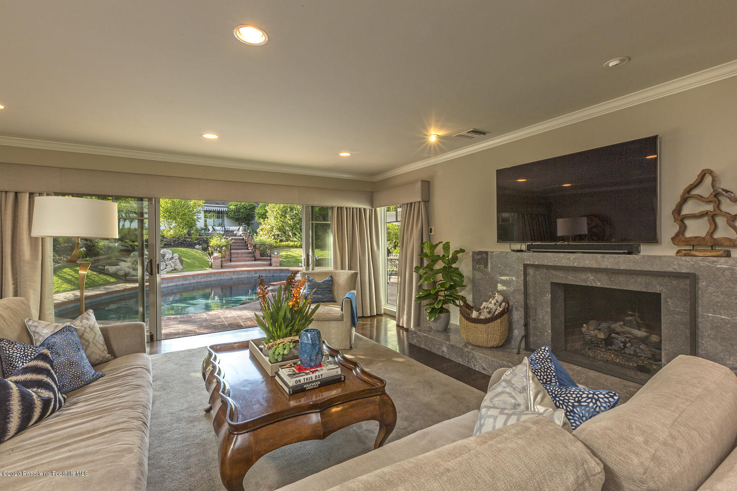 1175 Arden Road Pasadena, CA 91106 - Photo 9 of 30 a living room with furniture a flat screen tv and a fireplace