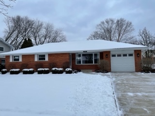 a view of a house with a yard covered with snow in front of house