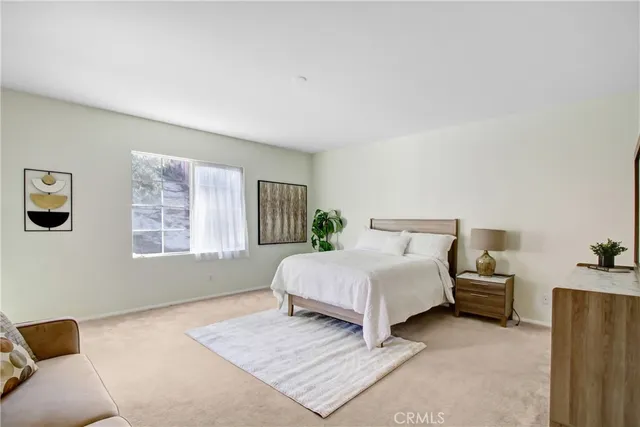 a bedroom with a bed and a couch