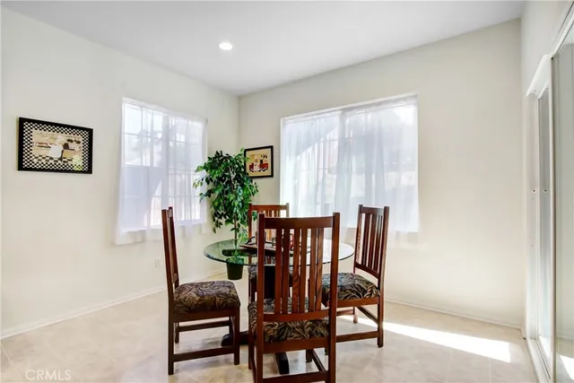 a view of a dining room with furniture and a potted plant