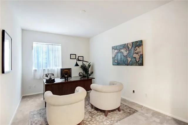 a living room with furniture a rug and a window