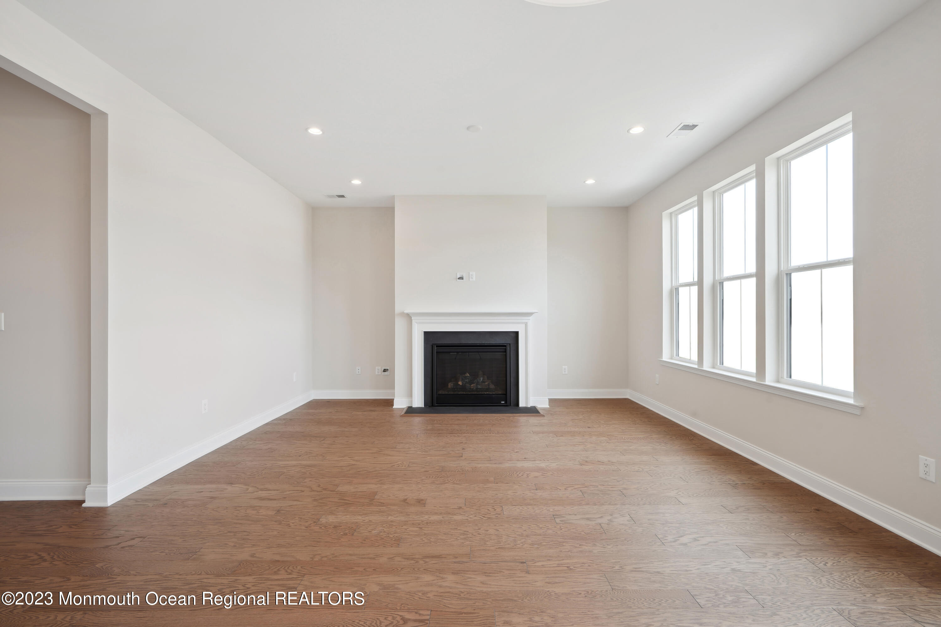 6 Salkin Way Freehold, NJ 07728 - Photo 3 of 14 an empty room with windows and fireplace