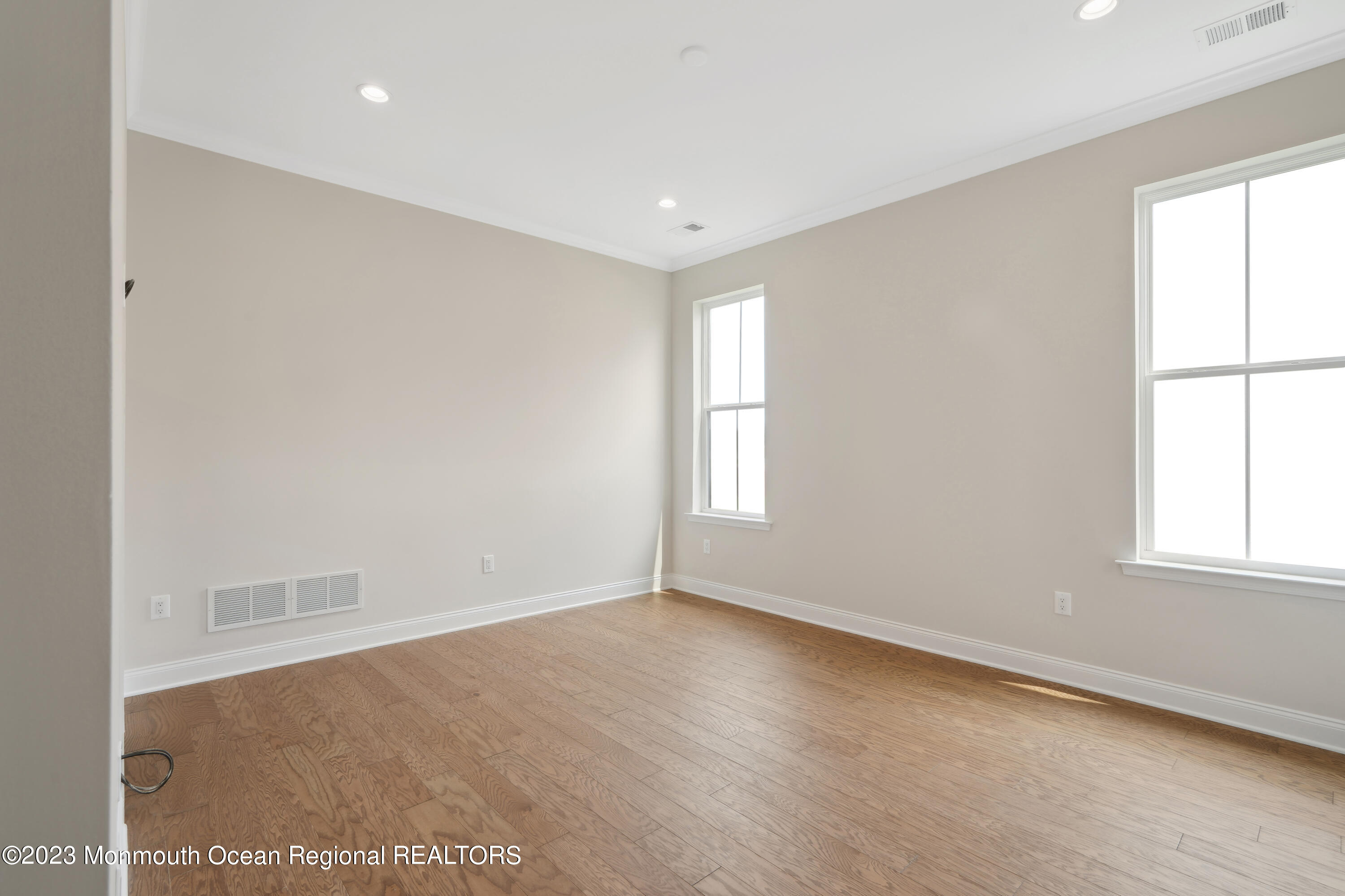 6 Salkin Way Freehold, NJ 07728 - Photo 9 of 14 an empty room with wooden floor and windows