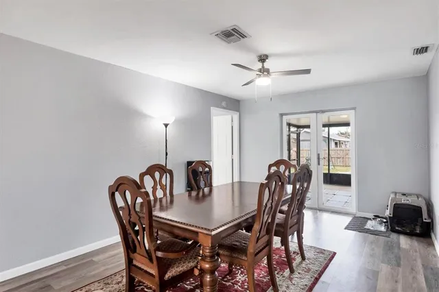 a view of a dining room with furniture and wooden floor