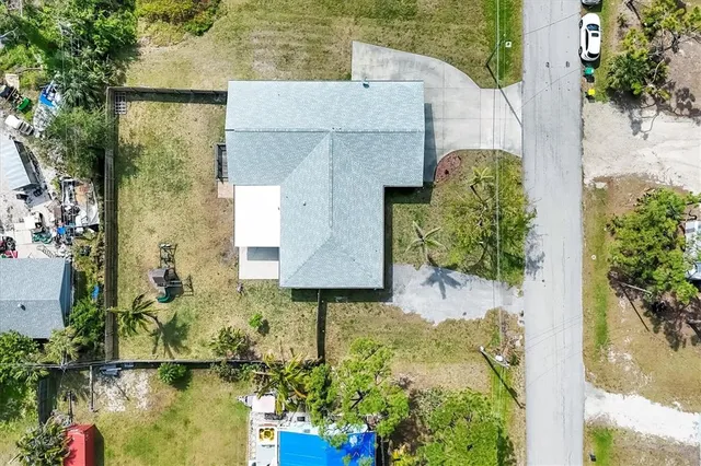 an aerial view of a house with a yard