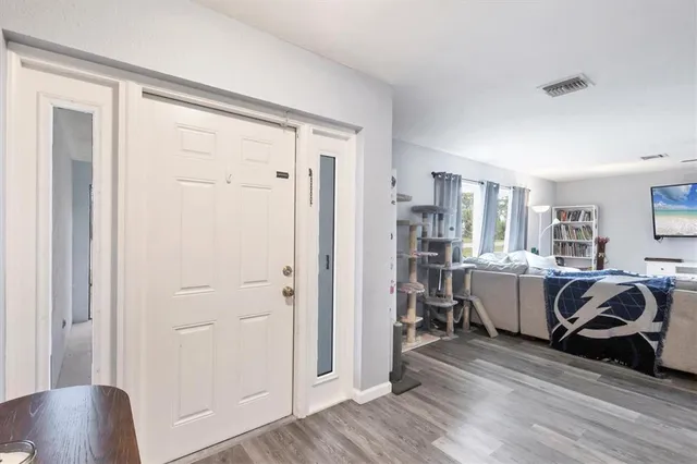 a view of a livingroom with furniture and hardwood floor