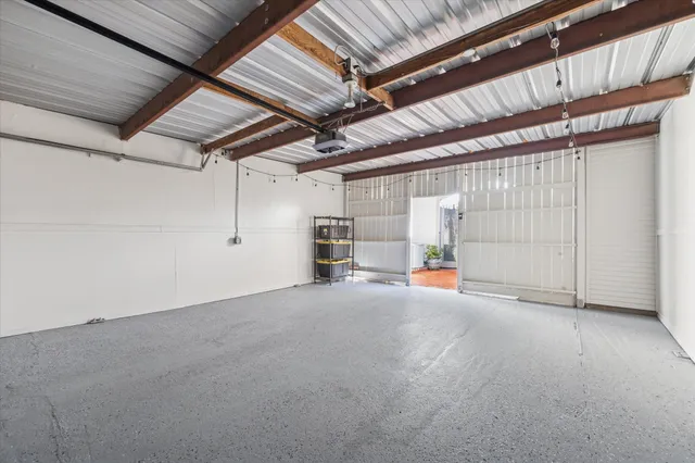 a view of empty room with wooden ceiling