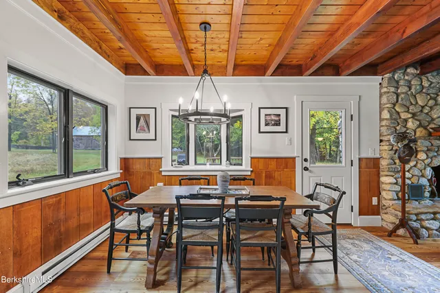 a living room with stainless steel appliances kitchen island granite countertop furniture and a wooden floor