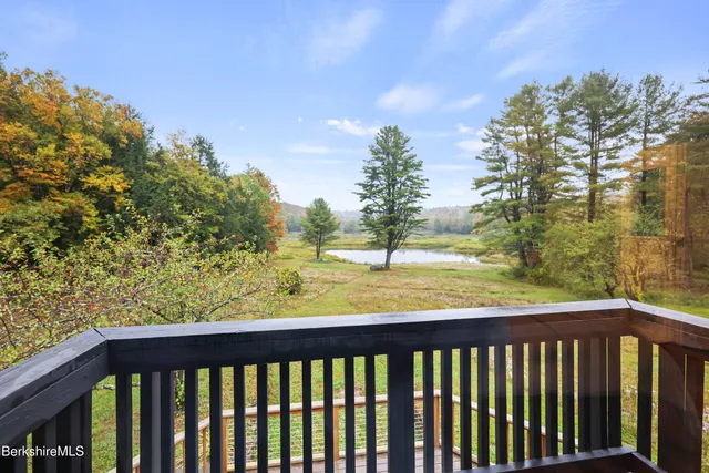 a bathroom with a granite countertop sink mirror vanity and toilet
