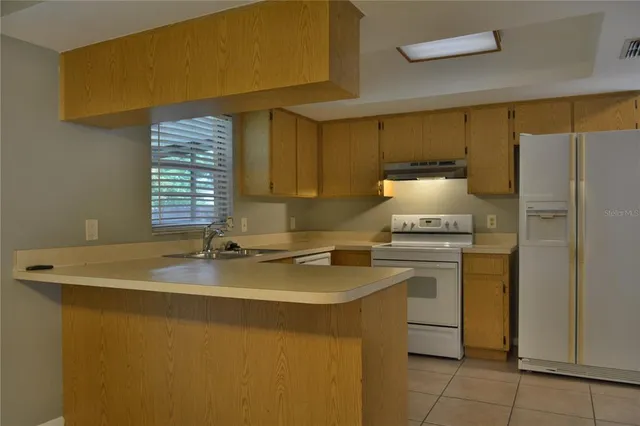 a kitchen with a stove a refrigerator a sink and dishwasher