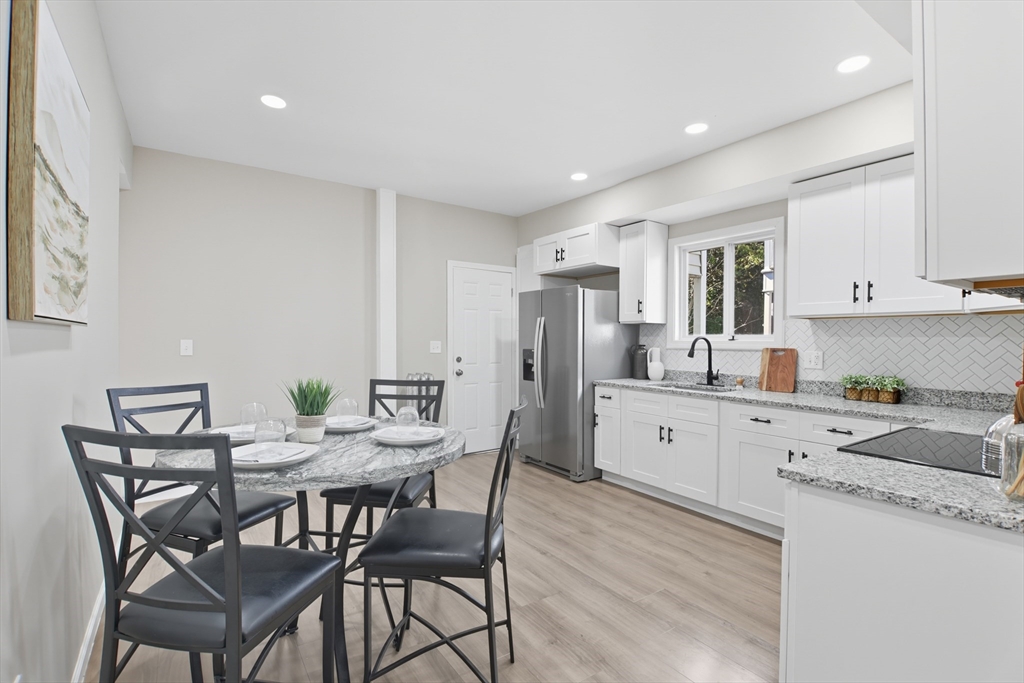 12 St James Avenue Holyoke, MA 01040 - Photo 8 of 42 a kitchen with stainless steel appliances a white table chairs and a refrigerator