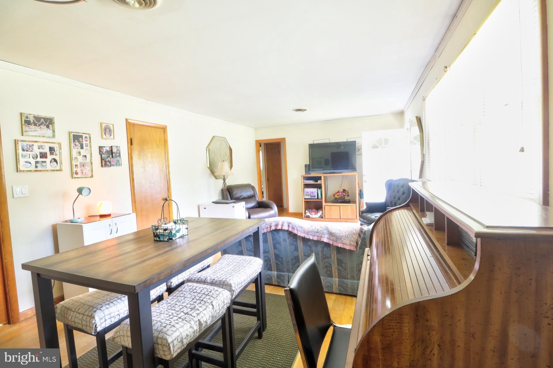 200 Burns Crossing Road Severn, MD 21144 - Photo 14 of 37 a view of a dining room with furniture and wooden floor