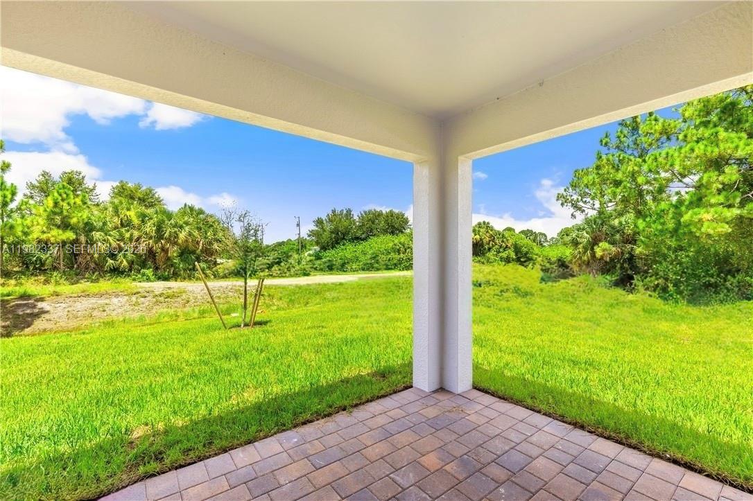 5215 Butte Street Lehigh Acres, FL 33971 - Photo 13 of 15 a view of a garden with an outdoor space