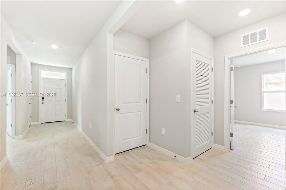 5215 Butte Street Lehigh Acres, FL 33971 - Photo 7 of 15 an empty room with windows and closet