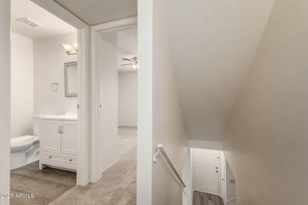 a bathroom with a granite countertop sink a toilet and a shower