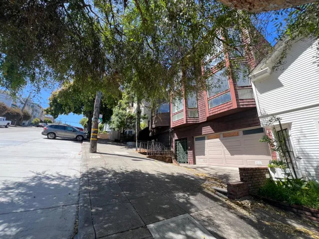a view of a street with houses on both side