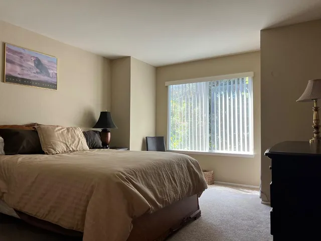 a bedroom with a bed and a window