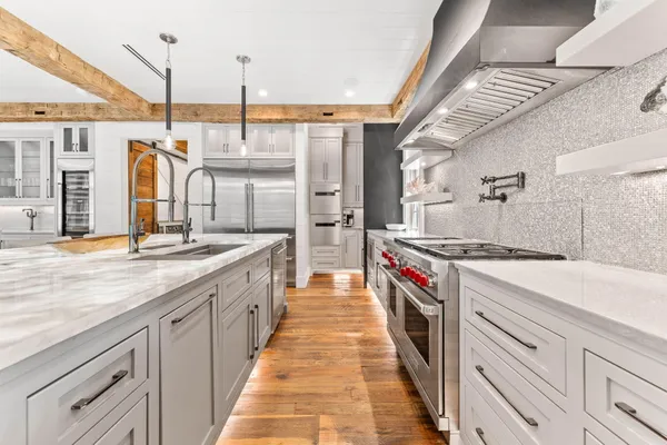 a bedroom with a bed a flat screen tv and a fireplace