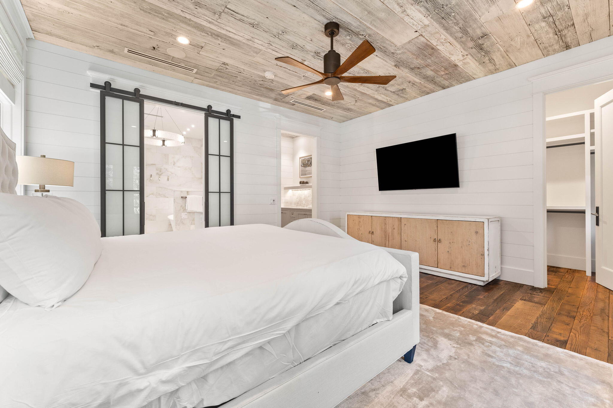 58 Coopersmith Ln Inlet Beach Inlet Beach, FL 32461 - Photo 53 of 130 a bedroom with a bed a flat screen tv and a fireplace