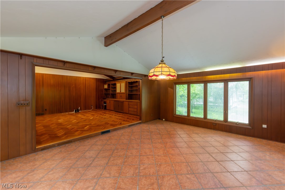 25001 Letchworth Road Beachwood, OH 44122 - Photo 20 of 50 Vaulted ceiling room featuring tiled flooring, a decorative pendant light fixture, and a wall of four large windows