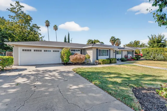a front view of a house with a yard and a garage