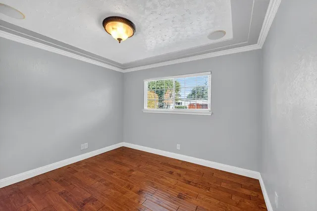 a view of a room with wooden floor and wall painting